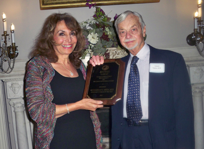 Mawya Shocair, M.D. accepting the award for Dr. Mohammad G. Reda and Dr. Hubert I. Caplan, M.D. presenting the award