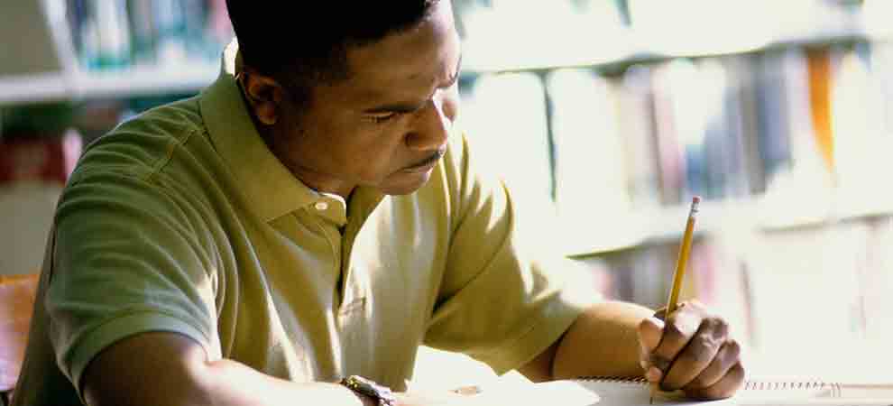 Adult man writing in a notebook