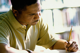 Adult man writing in a notebook