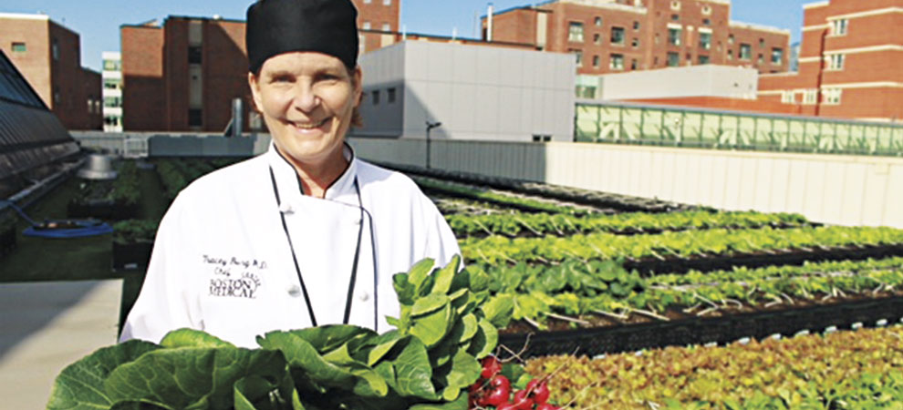 Tracey Burg, RD, teaching kitchen chef at Boston Medical Center at the hospital’s rooftop farm. <em>Photo: Boston Medical Center