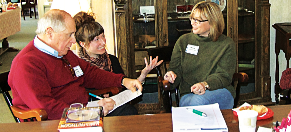 Edward Amaral, MD, and Marta Kushnir, MD, discuss their work with their instructor during a poetry workshop