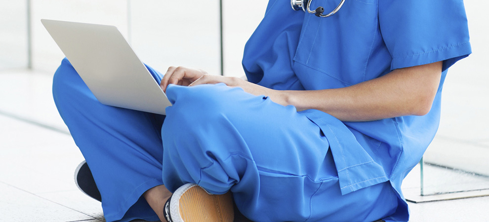 Medical resident working on laptop